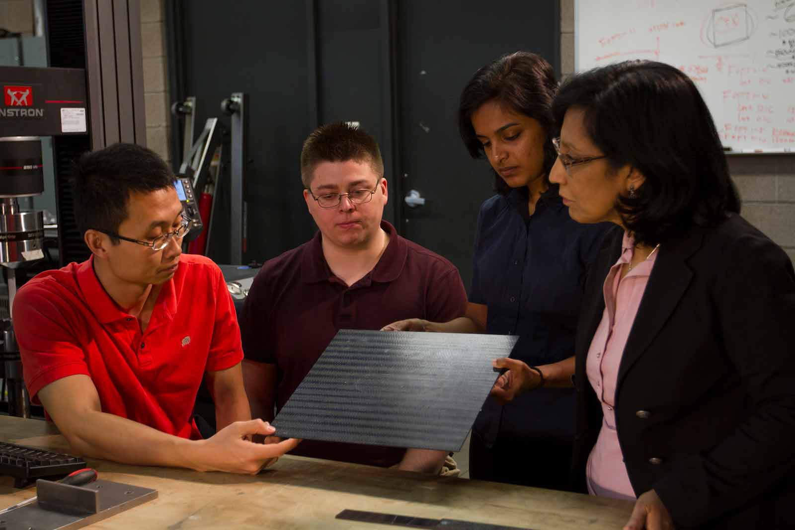 Aditi and a group of students look over materials