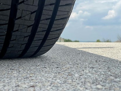 A close up view of a tire on top of pavement.