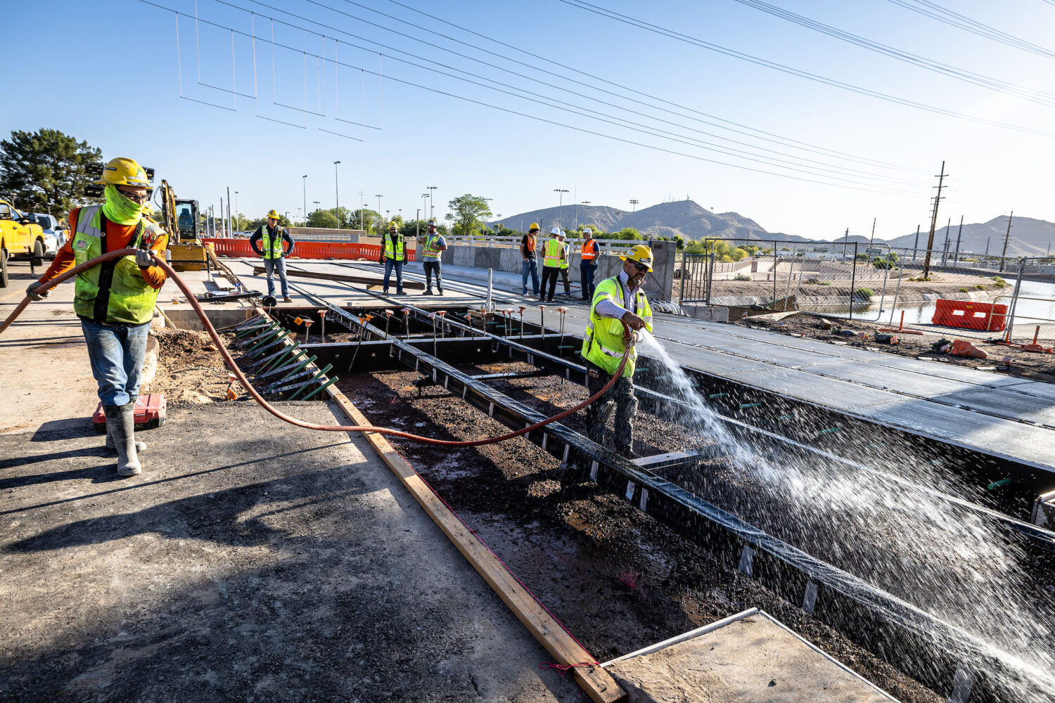 Workers prepare to pour the last section of concrete for the northern spur of the light rail line north of Dunlap Avenue
