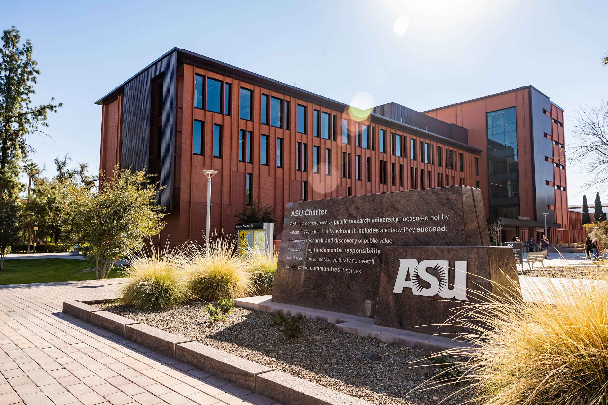 Image of the ASU Tempe campus with the ASU charter monument in the foreground