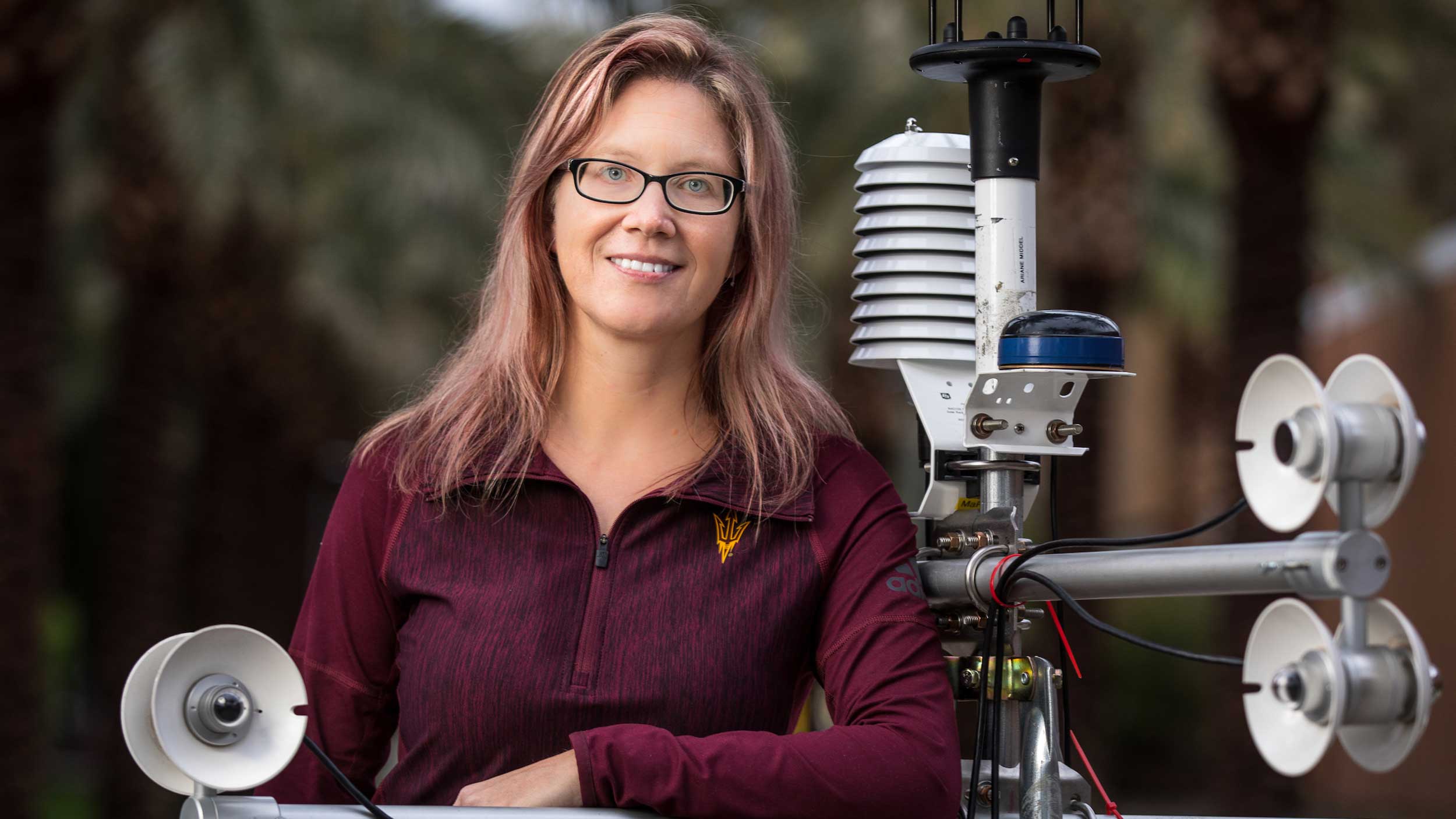 Portrait of Ariane Middel near some of her research equipment.